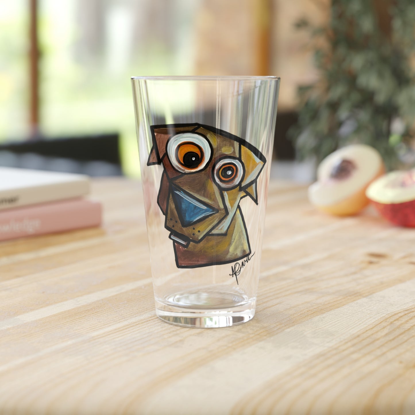 Clear glass with a dog illustration on a wooden surface