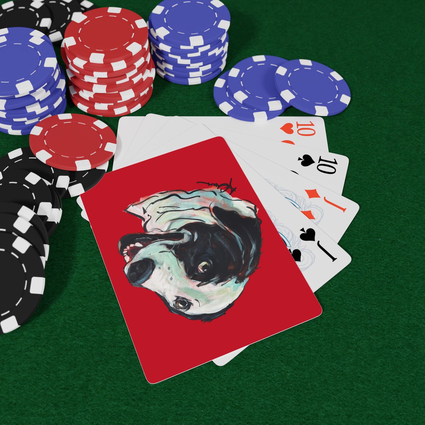 Set of red playing cards featuring a hand drawn custom dog caricature portrait on a poker table with poker chips.