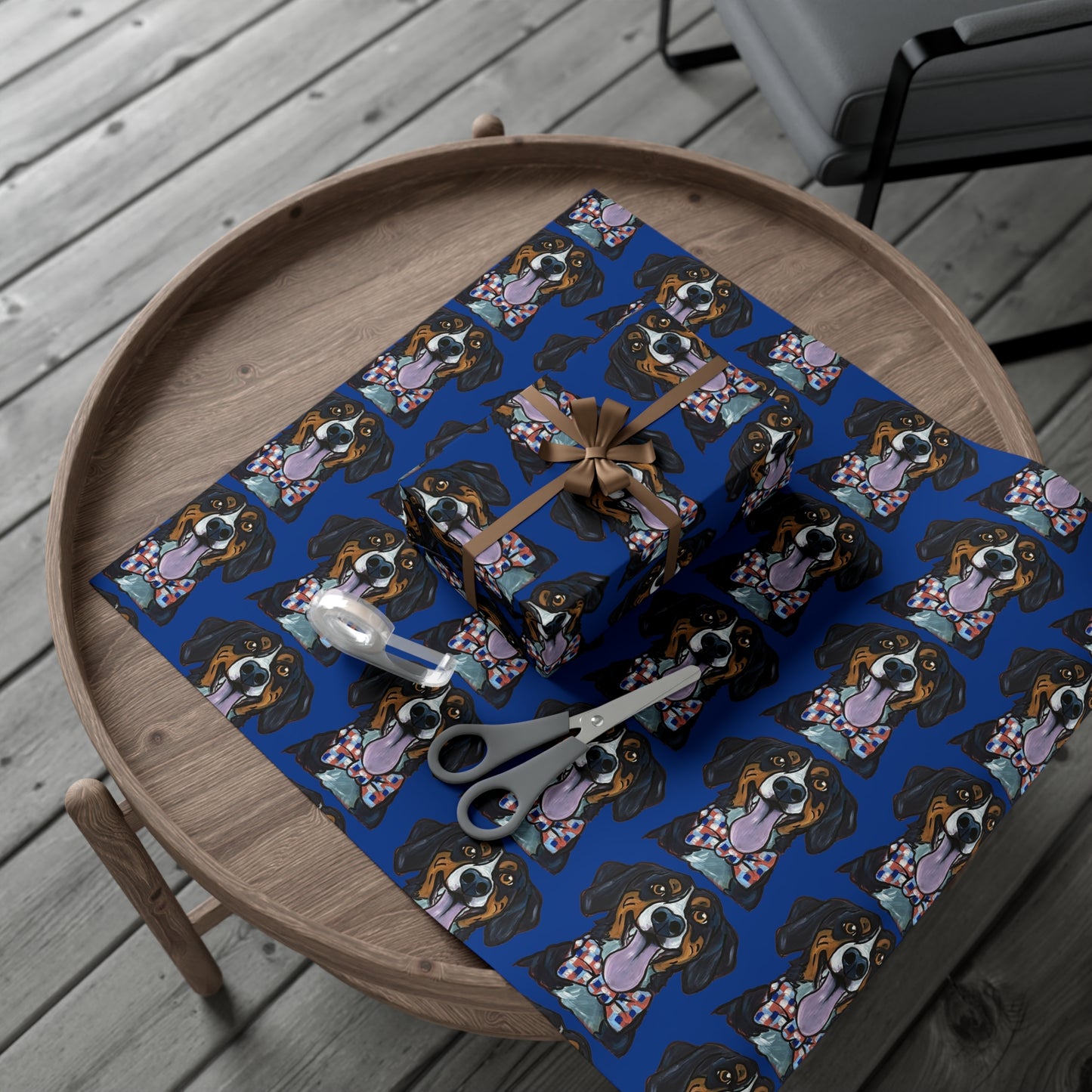 Gift wrapped in blue paper with dog pattern on a wooden tray