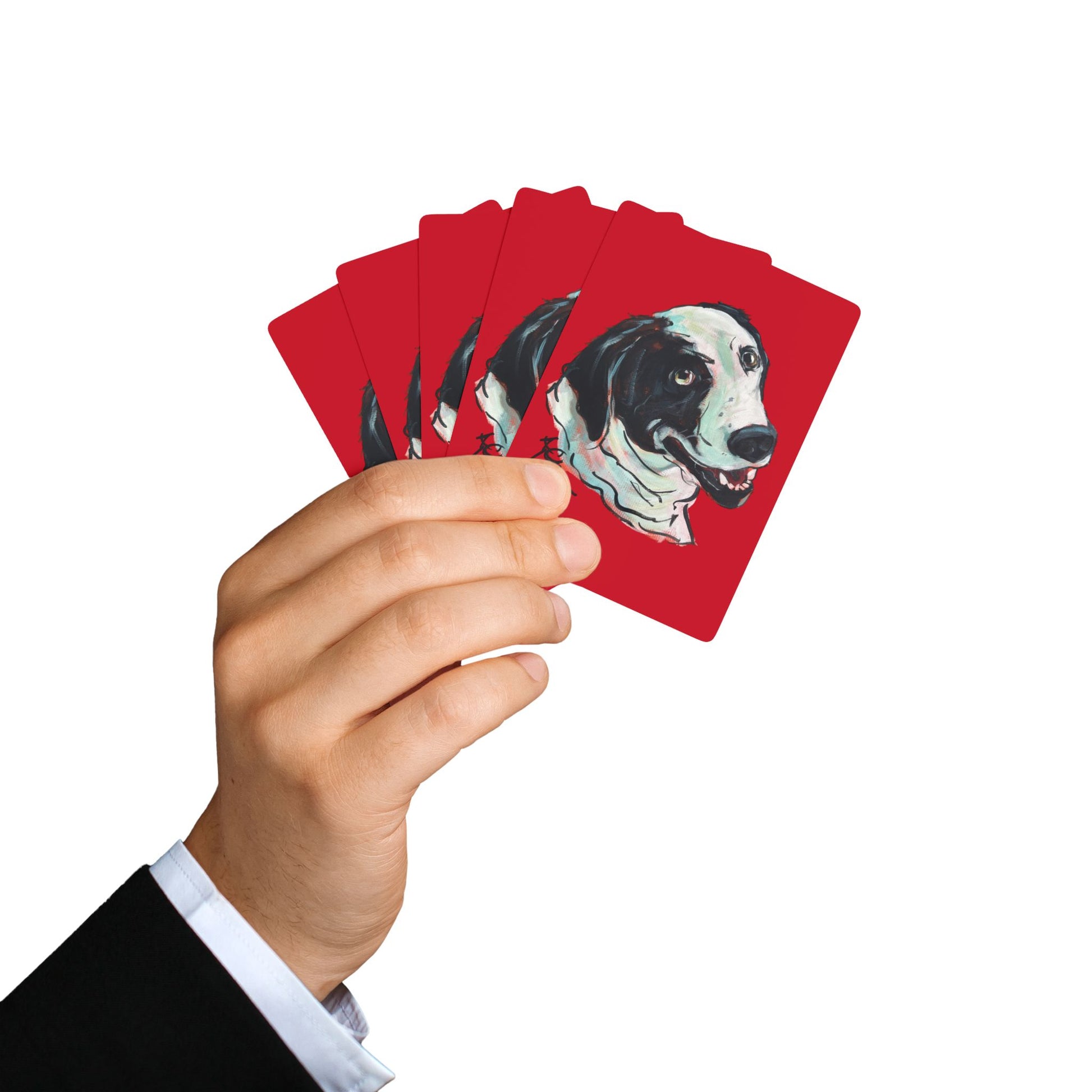 hand holding a Set of red playing cards featuring a hand drawn custom dog caricature portrait. 